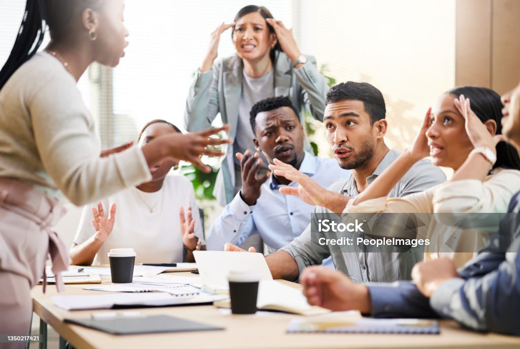 Cropped shot of a diverse group of businesspeople arguing during a meeting in the boardroom Sometimes ideas clash in the boardroom Conflict Stock Photo