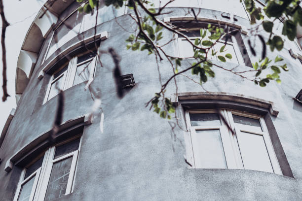 istock E bottom-up view concrete sky tower building medieval fortress knight castle lighthouses style. large window gray wall. Dark gray effect. Unusual architecture beauty Roof solution urban construction 1350227178