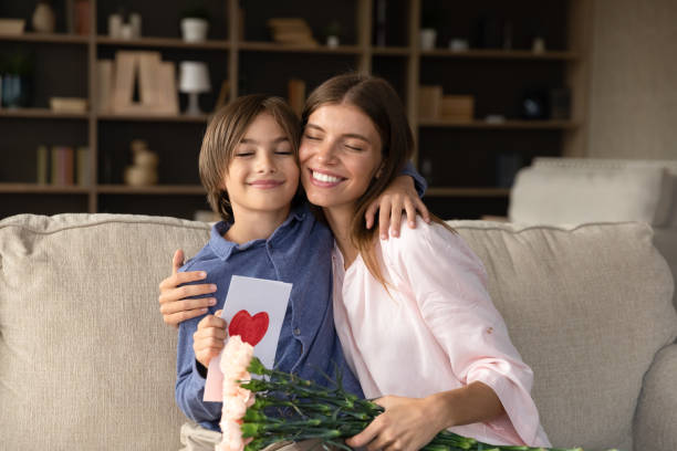 Happy young mother feeling thankful for present.