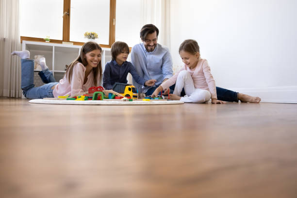 istock Happy young parents playing with little children. 1350227783