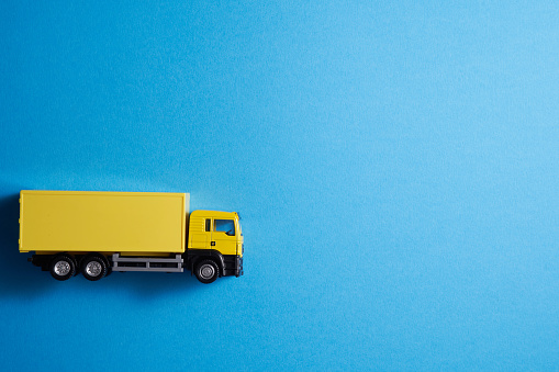 yellow Cargo Delivery Truck isolated on blue background