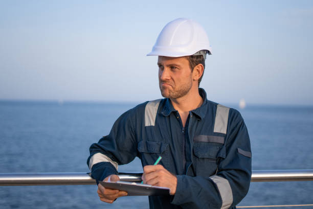 istock Inspector with clipboard in sea port 1350233841