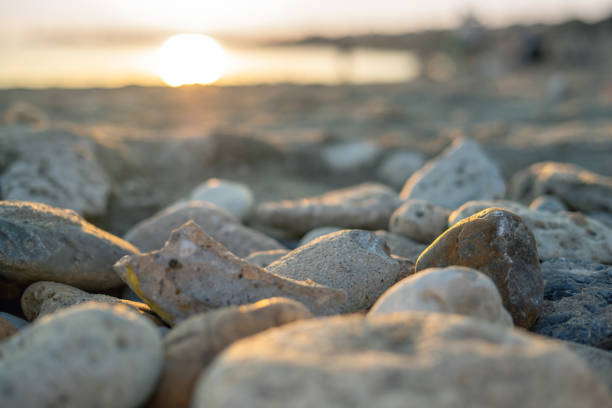 Close up of various coarse-grained stones on the beach