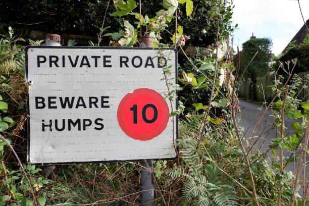 istock Sign saying private road, beware humps 1350234197