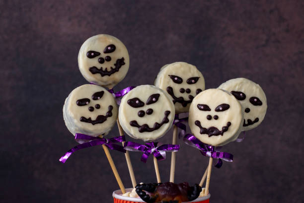 istock Homemade Halloween sweets cake pops skeletons with white chocolate. 1350234305
