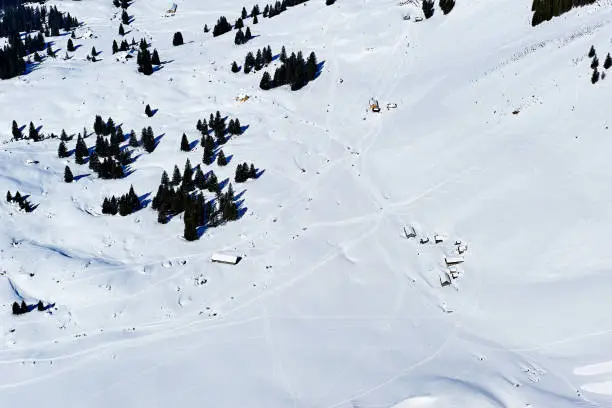 Aerial view of ski slope tracks on snowfield, Santis Mountain's  valley, Switzerland.