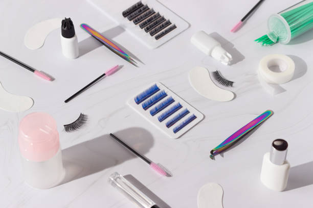 Things for the work of lash-makers, artificial eyelashes, microbrachis, glue, tweezers, combs, brushes for eyelash extensions. Eyelash extension, painting of eyebrows. Things for the work of lash-makers, artificial eyelashes, microbrachis, glue, tweezers, combs, brushes for eyelash extensions. Eyelash extension, painting of eyebrows. Eyelash Extensions stock pictures, royalty-free photos & images
