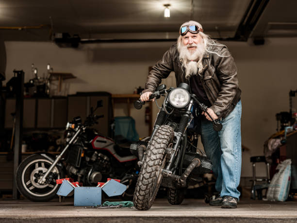 istock Senior man getting ready to ride his motorcycle 1350238217