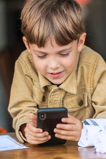 Caucasian Little boy using a smart phone