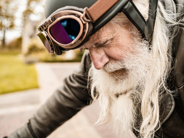 istock Senior man getting ready to ride his motorcycle 1350239217