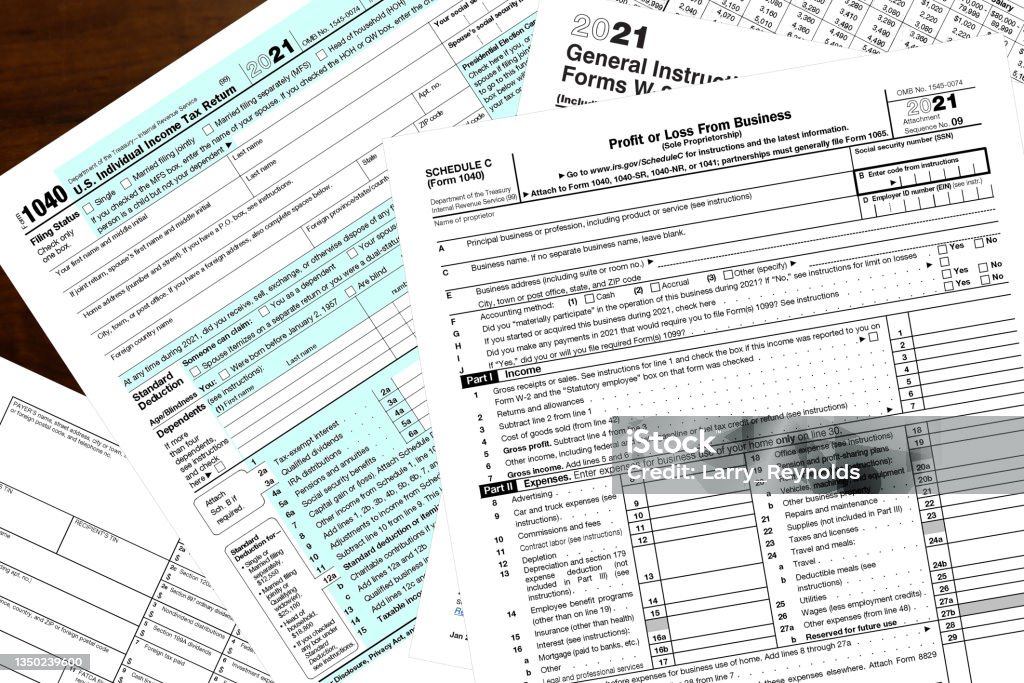 2021 IRS tax forms Various 2021 IRS tax forms on a wood desktop. Tax Form Stock Photo