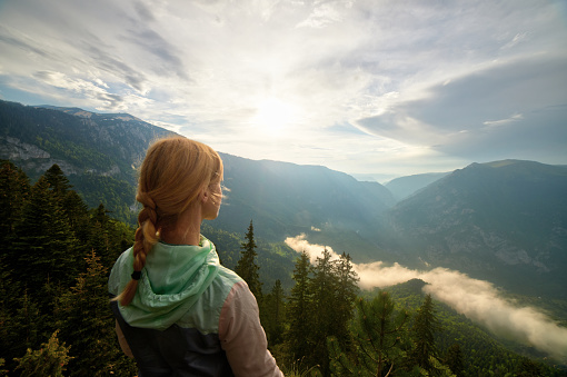 Young woman enjoying the view at mountain peak