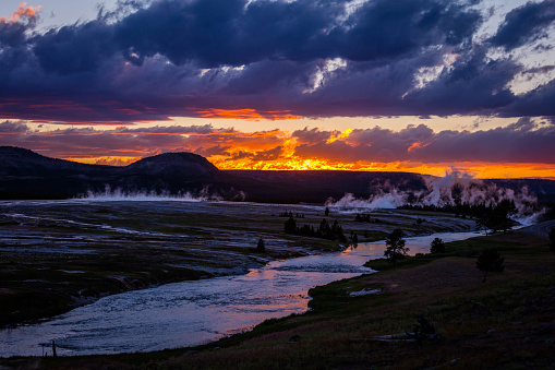 Amazing sunset at Yellowstone National Park, Wyoming. Beautiful sky above the geysers, unusual landscape.