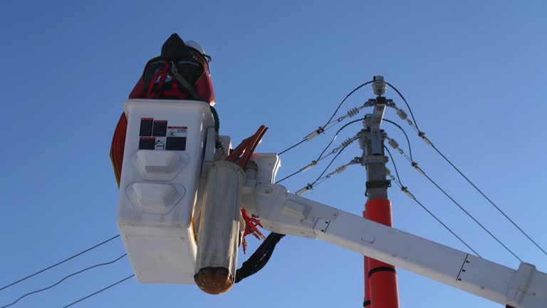 Electricians in truck cradle ready to repair power lines