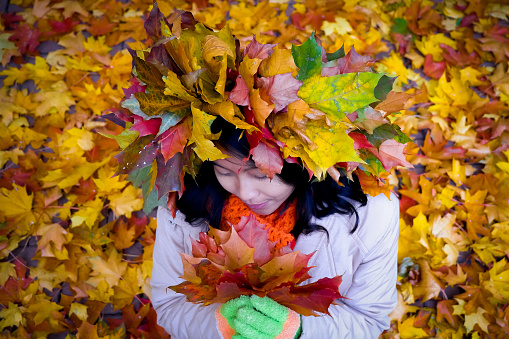 Girl with wreath of autumn leaves in autumn. St petersburg