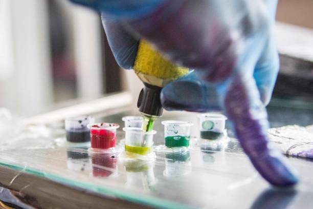 istock Tattoo machine and colourful ink, action close-up 1350247353