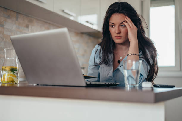 istock Businesswoman having a headache while working on a laptop at home 1350248721