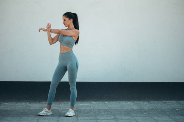 istock Attractive young woman doing fitness exercises while training outside 1350249471