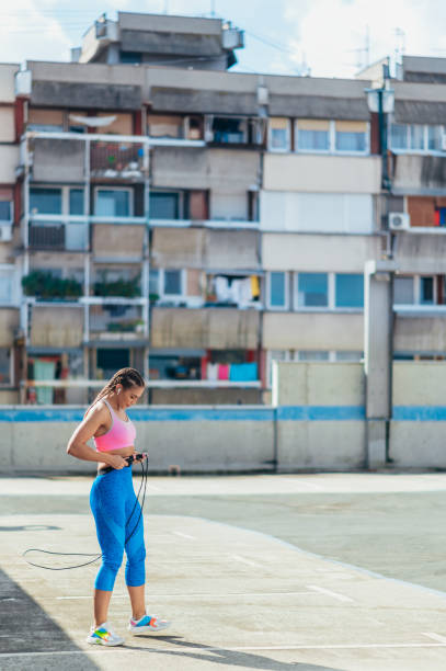 istock Attractive young woman using a fitness jump rope while training outside 1350249492