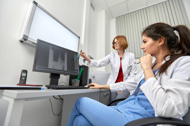 istock medical team discussing around a computer. Health care 1350250031