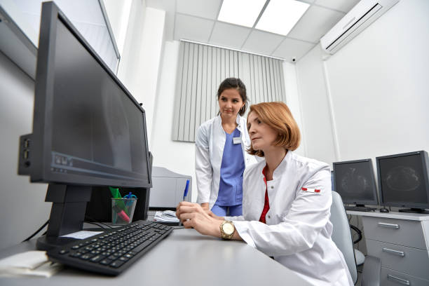 istock medical team discussing around a computer. Health care 1350250064