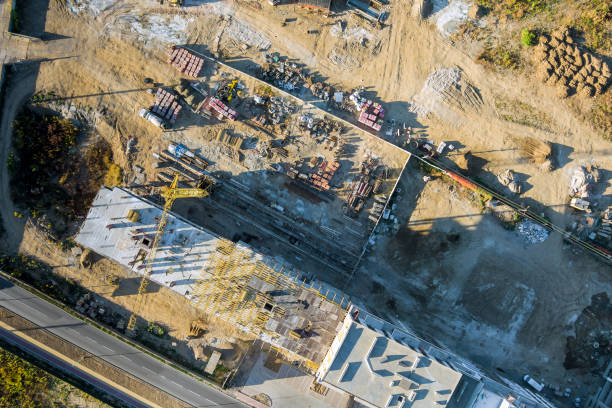 Panoramic top view several construction tower cranes of different heights at a building site during the construction