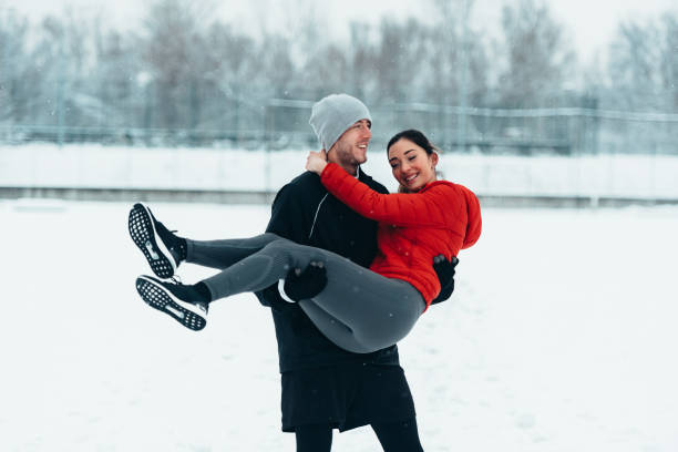 istock Young couple going for a run together during a snow 1350251507