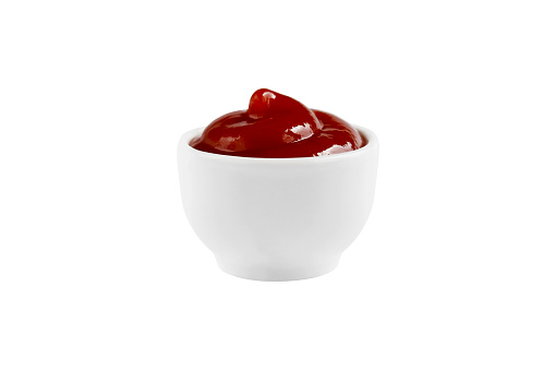 Top view of tomato sauce in a bowl on black background