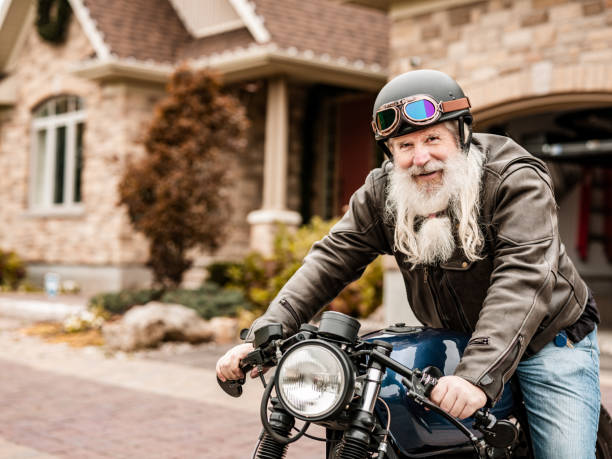 istock Senior man getting ready to ride his motorcycle 1350254479