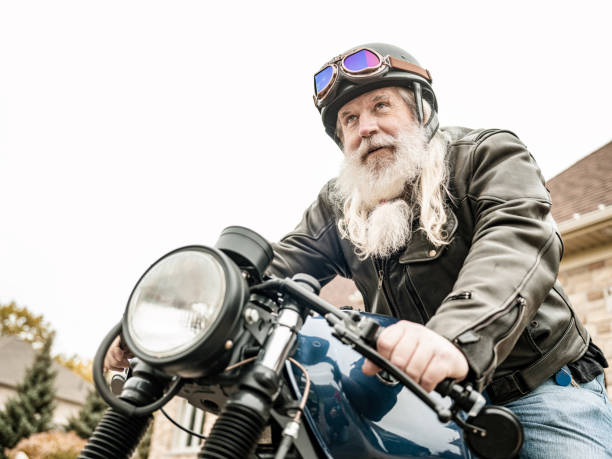istock Senior man getting ready to ride his motorcycle 1350254703