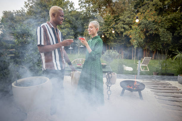 istock Multiracial couple having a dinner at their backyard 1350256003