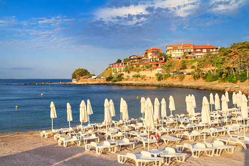 Coastal landscape - view of the beach with umbrellas in the Old Town of Nessebar, on the Black Sea coast of Bulgaria