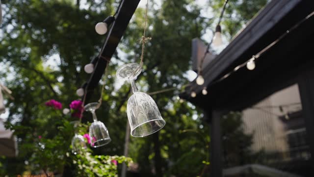 Street cafe summer terrace with drinking glasses hanging on rope