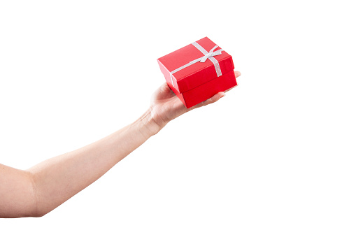 isolated female hand holding red gift box over white with copy space