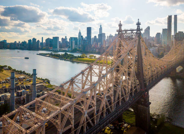 Aerial of Queensboro bridge on a cloudy day Aerial of Queensboro bridge New York with a view of East river and Roosevelt island. New York aerial roosevelt island stock pictures, royalty-free photos & images