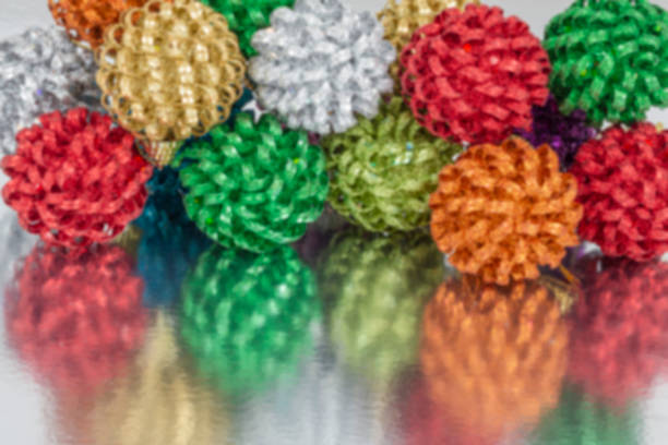 blurred new year background with colorful and shiny balls with reflection