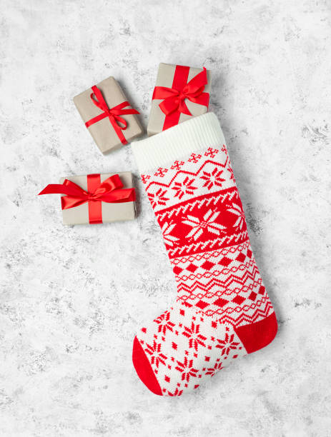 istock Christmas stocking white with gifts on a white background. 1350260471