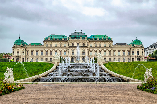 Vienna, Austria - October 06, 2021: Magnificent cascading fountains and sumptuous marble antique statues in the park of the Belvedere Palace in Vienna, the capital of Austria. Autumn rainy weather in Europe. Popular tourist and historical attraction, baroque architecture