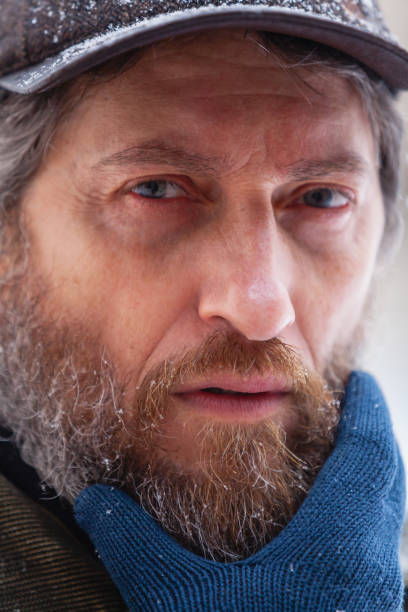 istock Man touches his beard with gloved hand 1350262294