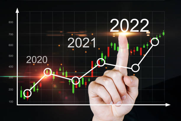 istock 2022. business man hand touching virtual screen graphic graph chart diagram on dark background, investment financial, stock market, trading statistic, business finance, digital technology concept 1350263231