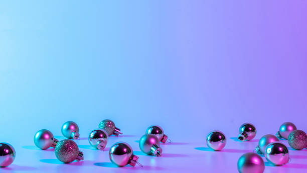 istock Christmas balls pattern neon background. Xmas bauble on abstract holiday winter gradient backdrop. Happy new year copy space. 1350264382