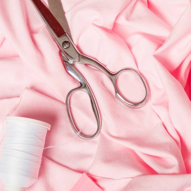 istock Fashion designer's workplace Various sewing materials, threads, spools, scissors, template and other sewing tools, tailor accessories. 1350265337