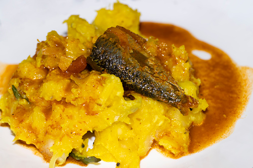 Closeup Image Of Kerala Style Yellow Tapioca With Fish Curry In White Background. Selective Focus