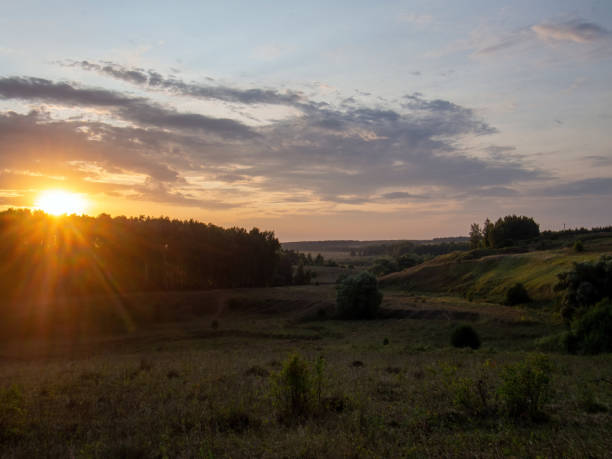 istock sunset on a clear day over a wooded ravine 1350266921