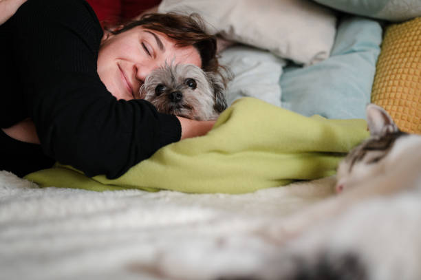 istock Woman playing with her cat and a dog 1350271764