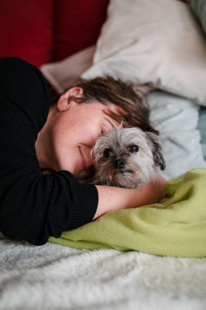istock Woman hugging her little dog 1350272263