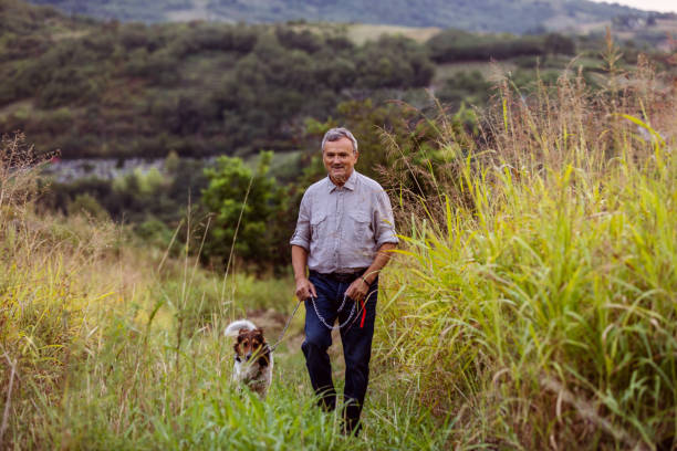 istock Senior Man Walking His Dog 1350273441