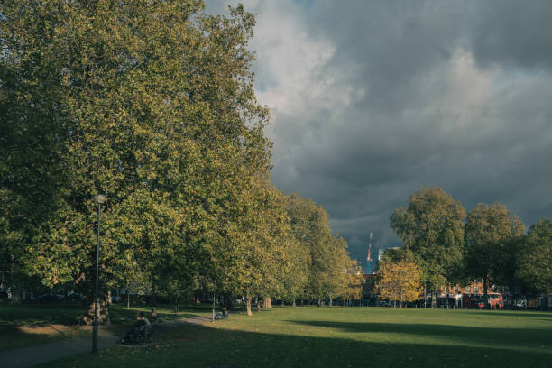 London, United Kingdom - 15 October 2020: People enjoying afternoon in Eel Brook Common in Fulham, London