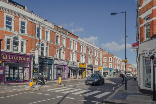 View of Fulham Road with cars and motorcycle in London stock photo