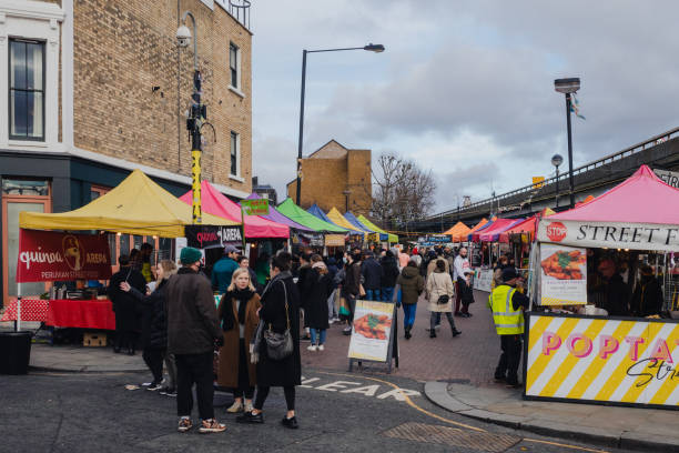 People gather at food market near Portobello road in Notting Hill, London stock photo